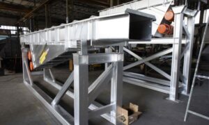 Industrial vibrating channel by Ghirarduzzi Srl, constructed from galvanized steel for durability and optimized for material handling and precision dosing in manufacturing environments.