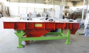 Red and green industrial vibrating feeder by Ghirarduzzi, built for efficient material handling and industrial precision.